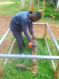 Daniel Muthoka installing water valve