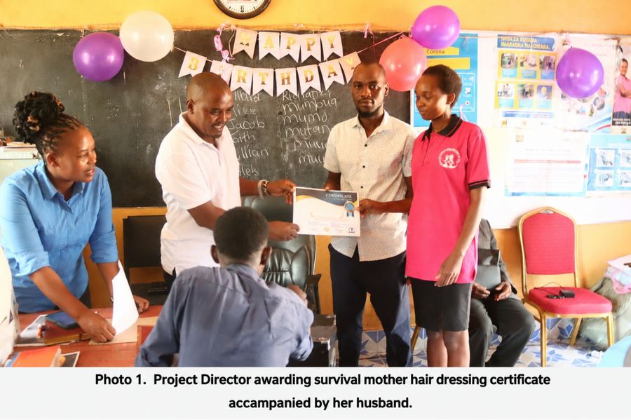 Project Director awarding a certificate to a survival mother