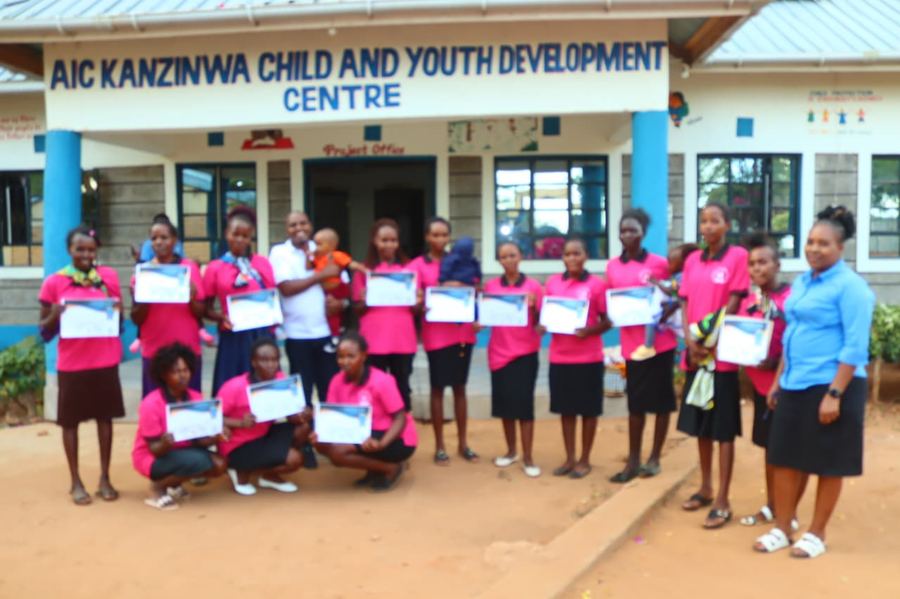 Group of graduating survival mothers in pink uniforms