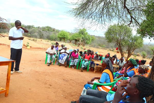 Speaker addressing community at child protection campaign