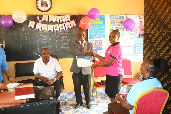 Pastor officiating hair dressing graduation ceremony